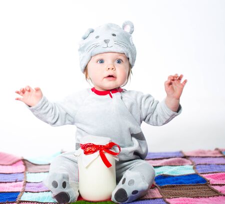 Little boy dressed as a cat with bank of milkの写真素材