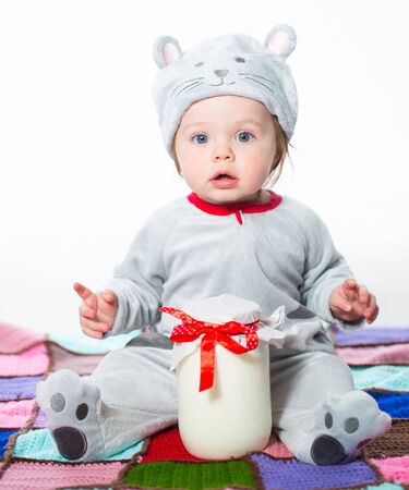 Little boy dressed as a cat with bank of milkの写真素材
