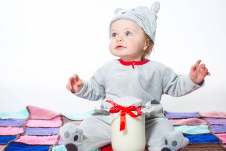 Little boy dressed as a cat with bank of milkの写真素材