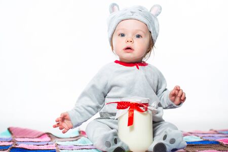 Little boy dressed as a cat with bank of milkの写真素材