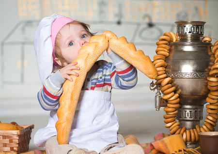 Little boy eating bred in bakeryの写真素材