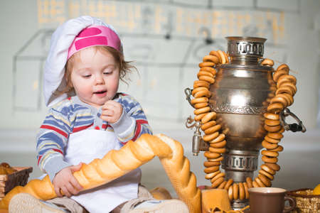 Little boy eating bred in bakeryの写真素材