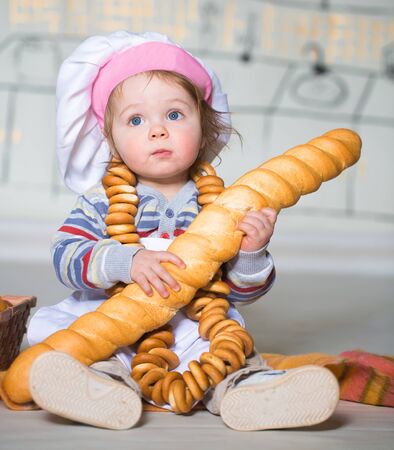 Little boy eating bred in bakeryの写真素材