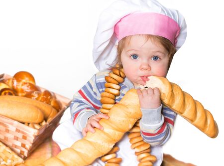 Little boy eating bred in bakeryの写真素材
