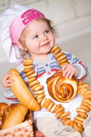 Little boy eating bred in bakeryの写真素材