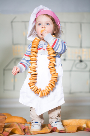 Little boy eating bred in bakeryの写真素材