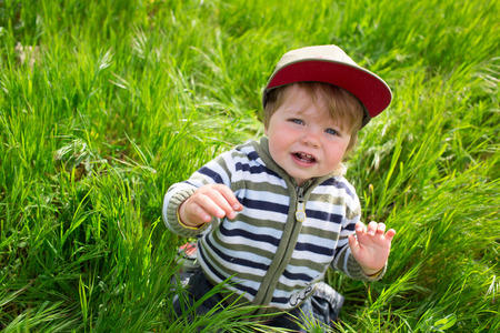Little boy playing in the grassの写真素材