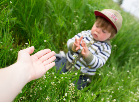Mother giving hand to the sonの写真素材