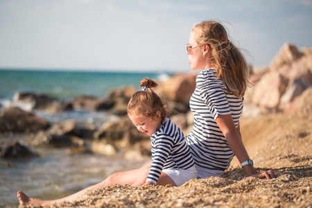Mother playing with child on the beachの写真素材