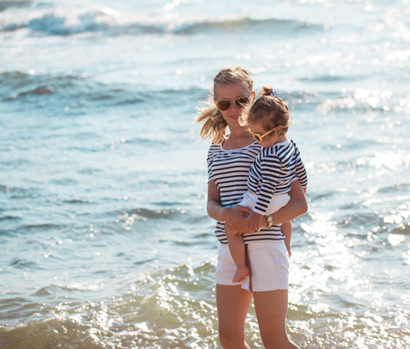 Mother playing with daughter on the beachの写真素材