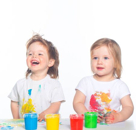 Little boy and girl playing with paintsの写真素材
