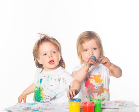 Little boy and girl playing with paintsの写真素材