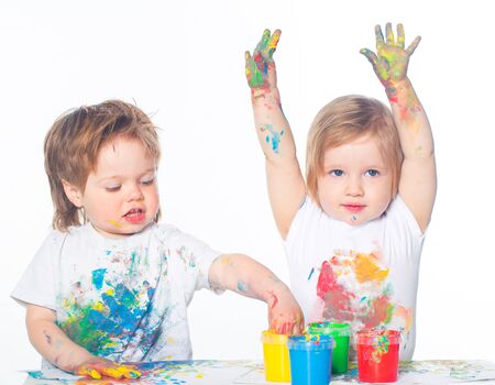 Little boy and girl playing with paintsの写真素材