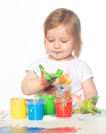 Little girl playing with paintsの写真素材
