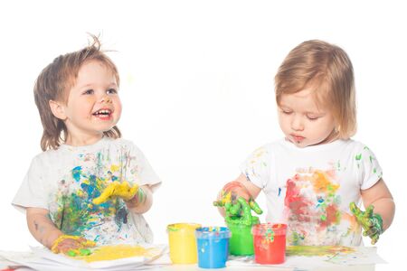 Little boy and girl playing with paintsの写真素材