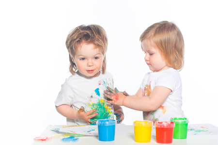 Little boy and girl playing with paintsの写真素材