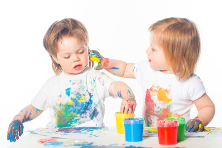 Little boy and girl playing with paintsの写真素材