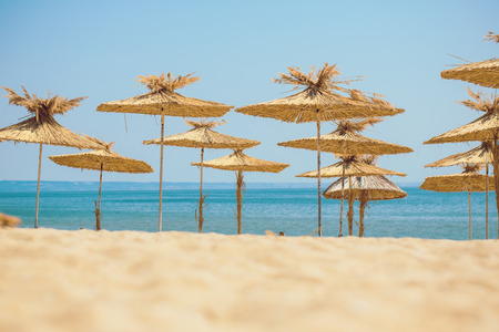 Beach umbrellas on exotic tropical white sand beachの写真素材