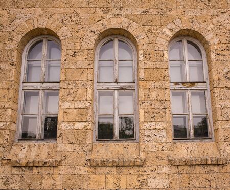 The ancient building. facade with three high windowsの写真素材