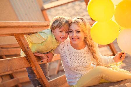 Mother playing with son in the parkの写真素材