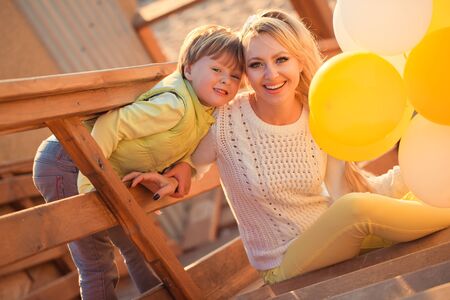 Mother playing with son in the parkの写真素材