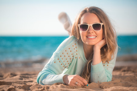 Beautiful girl lying on the beachの写真素材