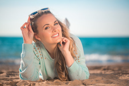 Beautiful girl lying on the beachの写真素材