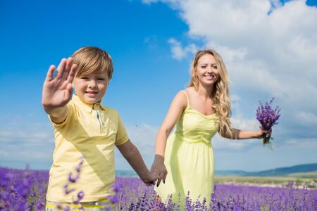 Mother with little son on lavender fieldの写真素材