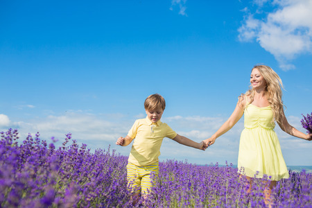 Mother with little son on lavender fieldの写真素材