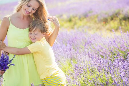 Mother with little son on lavender fieldの写真素材