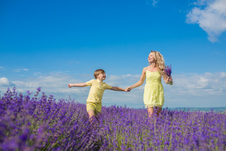 Mother with little son on lavender fieldの写真素材