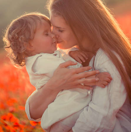 Family playing on poppy fieldの写真素材