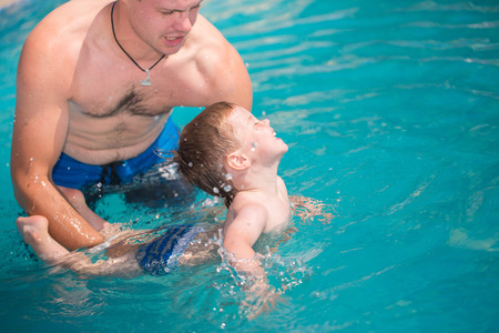 Child playing in swimming poolの写真素材