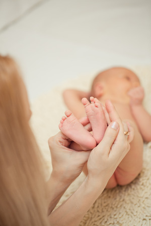 Baby feet in mother hands. Mom and her Child. Happy Family concept.の写真素材