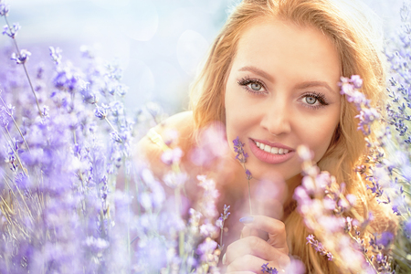 Beautiful young woman portrait in lavender fieldの写真素材