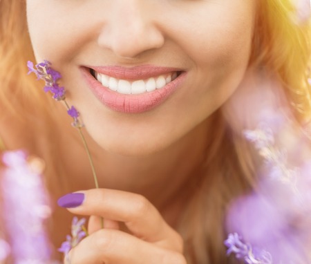 Beautiful young woman portrait in lavender fieldの写真素材