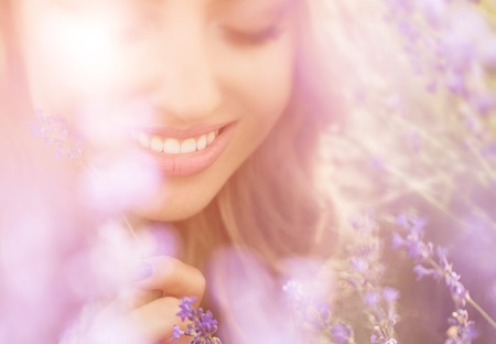 Beautiful young woman portrait in lavender fieldの写真素材
