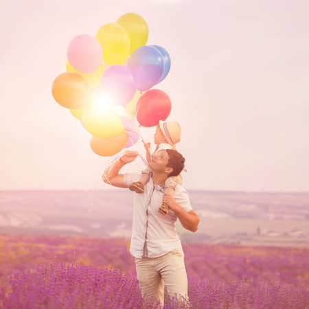 Father with son playing on lavender fieldの写真素材