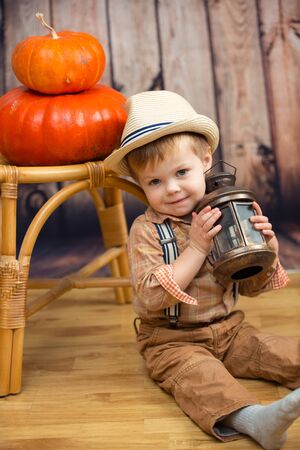 Little boy with pumpkin on the farmの写真素材