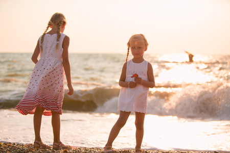 Two little girls playing on the beachの写真素材