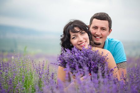 Young beautiful couple harvesting lavender flowers in franceの写真素材