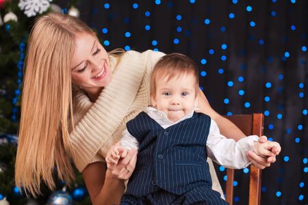 Mother and son portrait near wall with lights