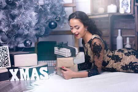 Young beautiful woman at christmas night with presentsの写真素材