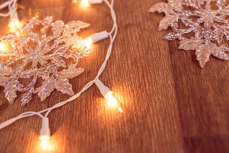 Backgroung of christmas garland lights on the wooden floorの写真素材