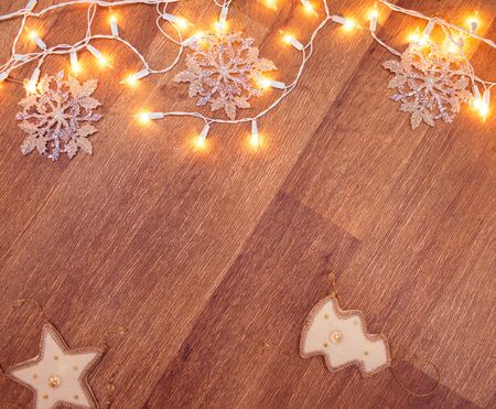 Backgroung of christmas garland lights on the wooden floorの写真素材