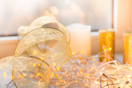 Decoration xmas gold color ribbon with candles on backgroundの写真素材