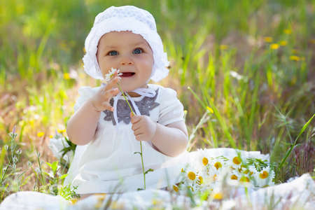 Beautiful child girl on the flower meadow