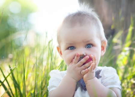 Beautiful child girl on the flower meadowの写真素材
