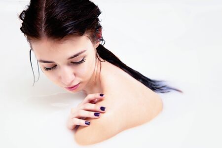 Beautiful girl in a bath of milkの写真素材