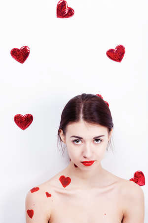 Brunette girl with red hearts isolated on whiteの写真素材